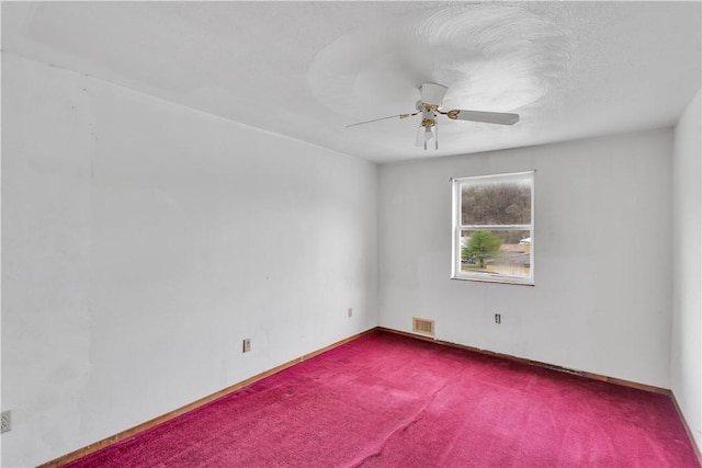 unfurnished room featuring baseboards, visible vents, carpet flooring, and a ceiling fan