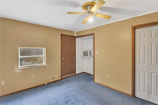 unfurnished bedroom with visible vents, crown molding, carpet, baseboards, and a ceiling fan