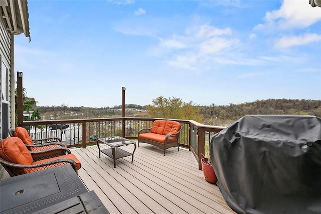 deck with an outdoor living space and area for grilling