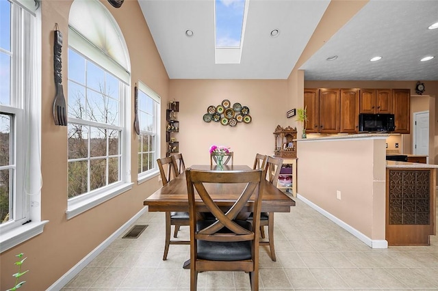 dining area with light tile patterned floors, baseboards, recessed lighting, and visible vents