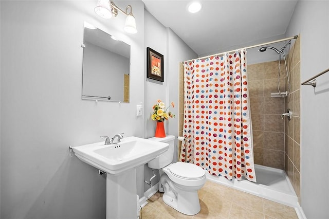 bathroom featuring toilet, a shower stall, and tile patterned flooring