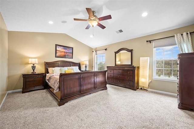 bedroom with visible vents, baseboards, lofted ceiling, and light colored carpet