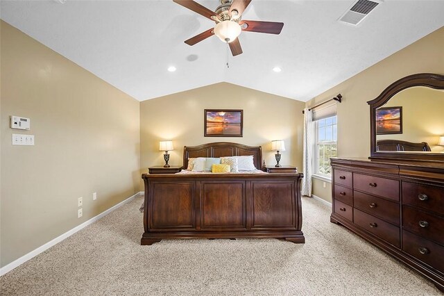 bedroom featuring light colored carpet, baseboards, vaulted ceiling, and visible vents