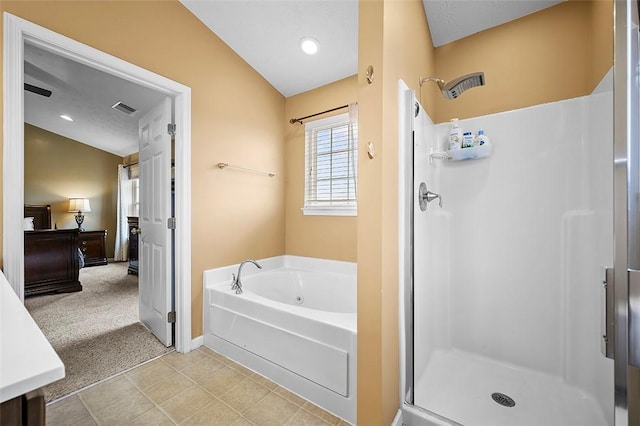 bathroom featuring baseboards, a shower stall, a garden tub, and visible vents