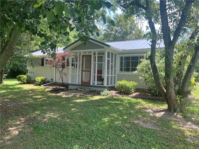 55 Evergreen, West Salem Twp, PA 16125 - view of front of home featuring a front lawn, a sunroom, and a metal roof