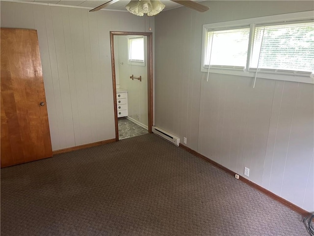55 Evergreen, West Salem Twp, PA 16125 - carpeted spare room featuring a baseboard radiator, a ceiling fan, and wooden walls