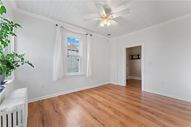 unfurnished room featuring crown molding, a ceiling fan, light wood finished floors, radiator heating unit, and baseboards