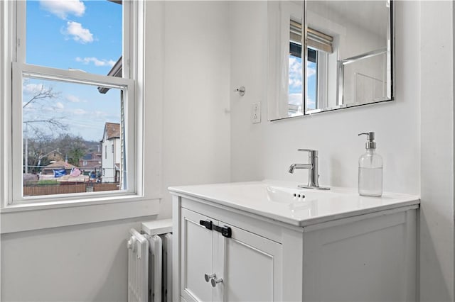 bathroom with radiator and vanity