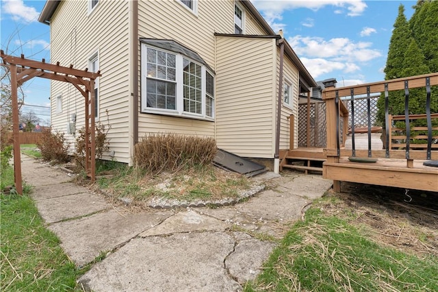 view of side of property featuring a wooden deck