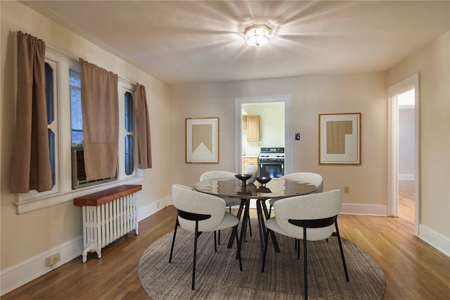 7447 Schoyer Ave, Swissvale, PA 15218 - dining area with radiator, wood finished floors, and baseboards