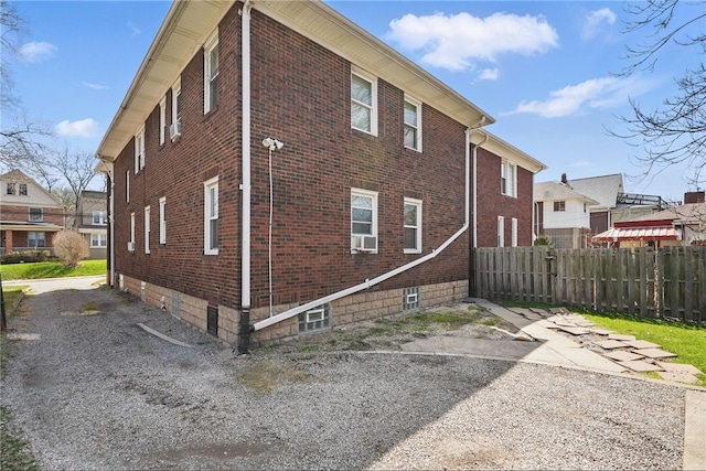7447 Schoyer Ave, Swissvale, PA 15218 - view of side of home with cooling unit, fence, and brick siding