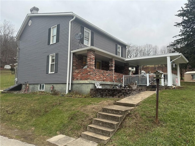 966 Fayette City Rd, Fayette City, PA 15438 - view of side of home featuring brick siding, a lawn, a porch, and a chimney