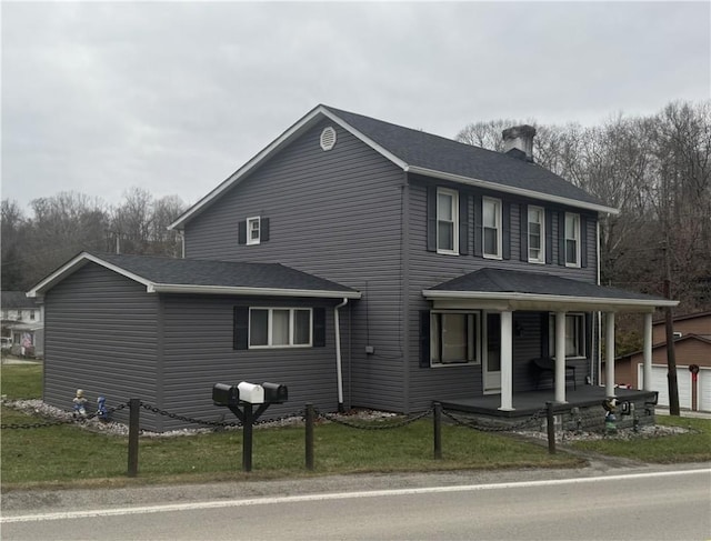 966 Fayette City Rd, Fayette City, PA 15438 - view of front of home with a front yard, an outbuilding, a porch, and a chimney