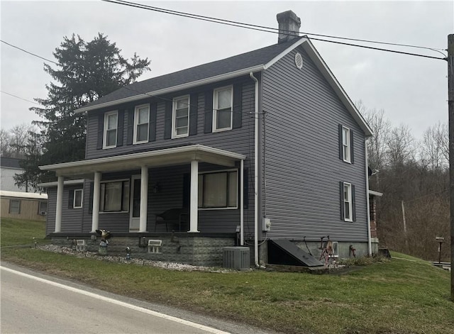966 Fayette City Rd, Fayette City, PA 15438 - colonial home with a porch, a front yard, central AC unit, and a chimney