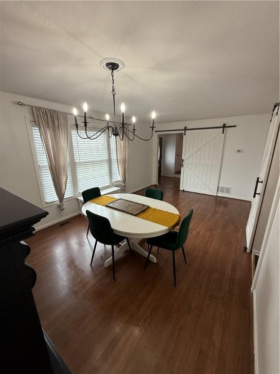5 Trotwood Cir, North Strabane, PA 15317 - dining area with a barn door, a chandelier, dark wood-style flooring, and healthy amount of natural light