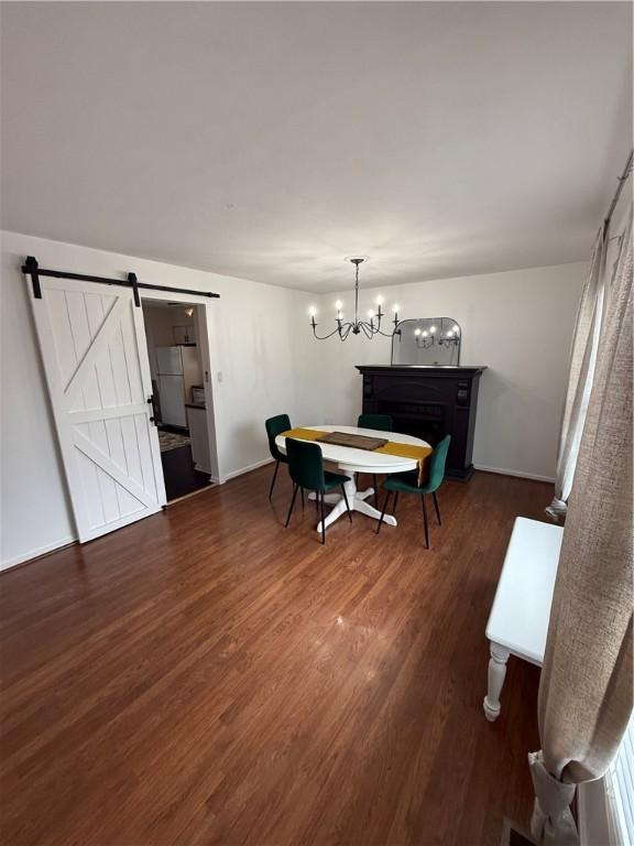 5 Trotwood Cir, North Strabane, PA 15317 - dining space featuring wood finished floors, a barn door, a chandelier, and baseboards