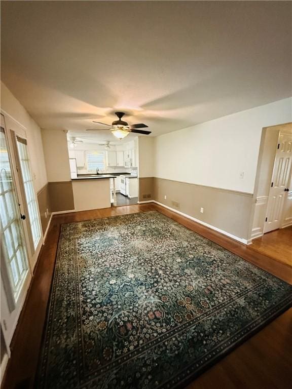 5 Trotwood Cir, North Strabane, PA 15317 - unfurnished living room with wood finished floors, ceiling fan, and baseboards