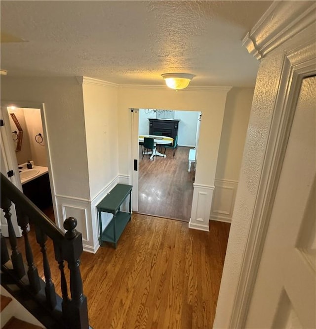 5 Trotwood Cir, North Strabane, PA 15317 - corridor featuring a textured ceiling, wood finished floors, a sink, a decorative wall, and ornamental molding