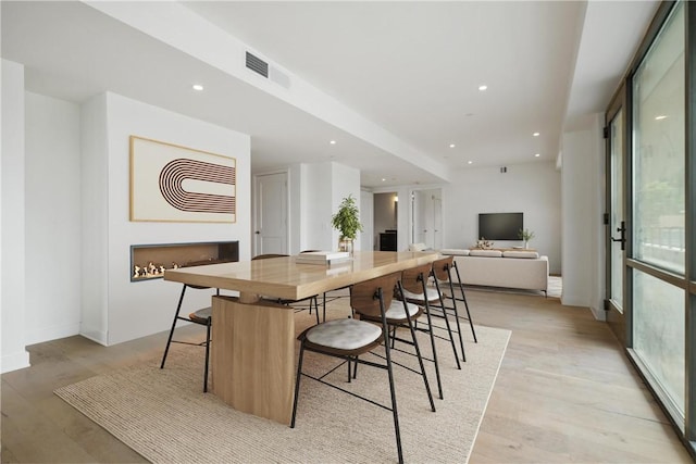 dining area with recessed lighting, visible vents, light wood-type flooring, and a healthy amount of sunlight