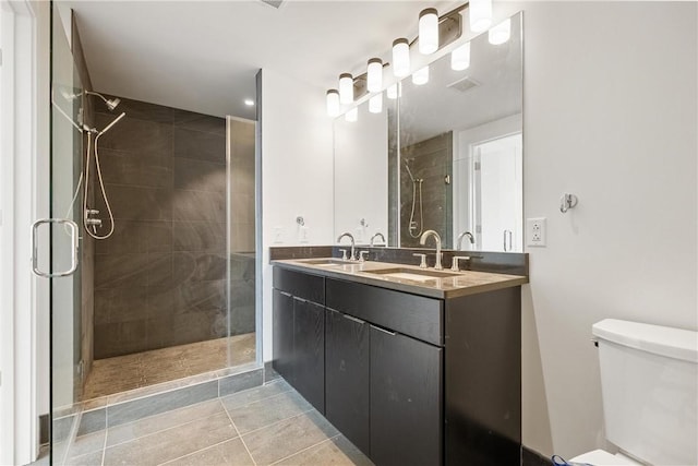 bathroom featuring a sink, toilet, and a shower stall