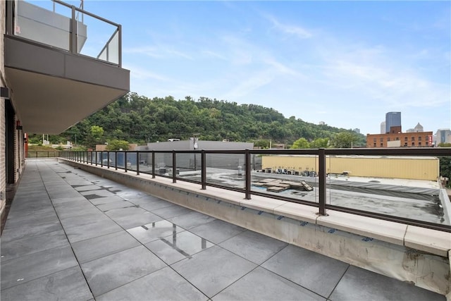 view of patio / terrace featuring a view of city and a balcony