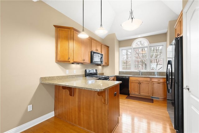 1728 Waterleaf Dr, Franklin Park, PA 15143 - kitchen with light wood-style flooring, a peninsula, vaulted ceiling, black appliances, and a sink