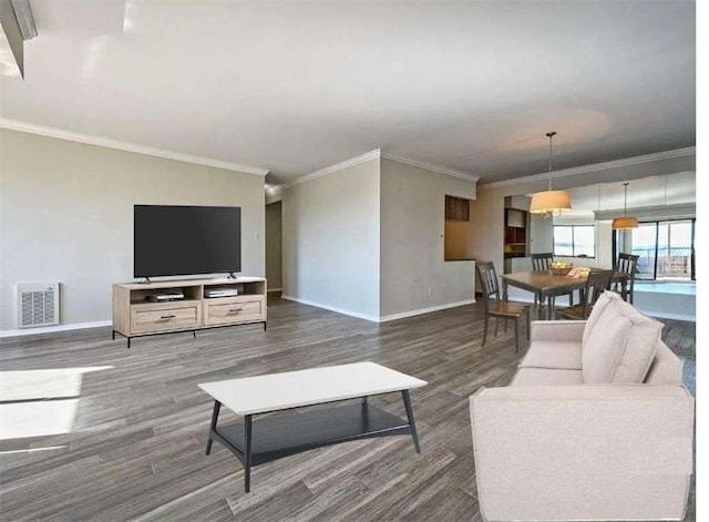 living room featuring wood finished floors, visible vents, crown molding, and baseboards
