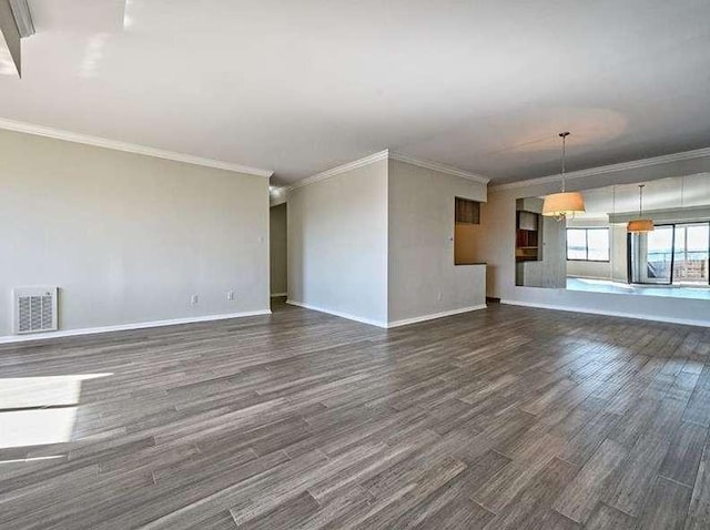 unfurnished living room featuring baseboards, visible vents, ornamental molding, and dark wood-style flooring