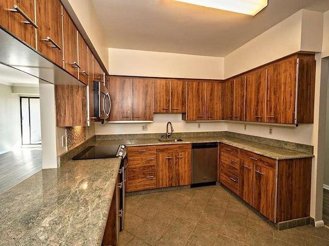 kitchen featuring brown cabinets, appliances with stainless steel finishes, and a sink