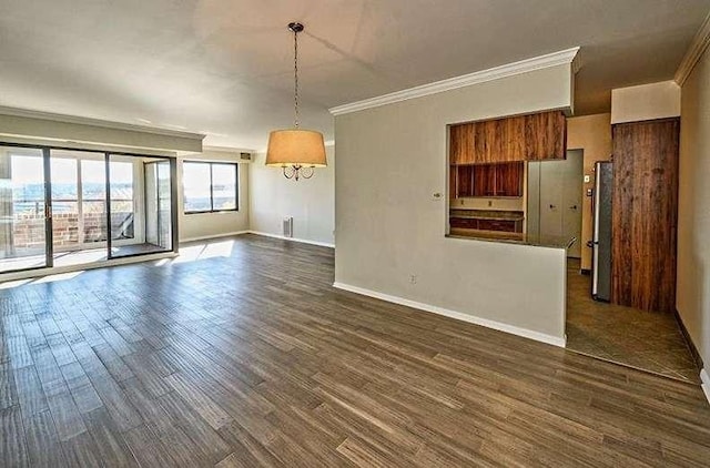 spare room featuring dark wood-style floors, baseboards, and crown molding