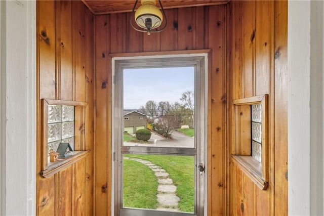 doorway to outside featuring wooden walls