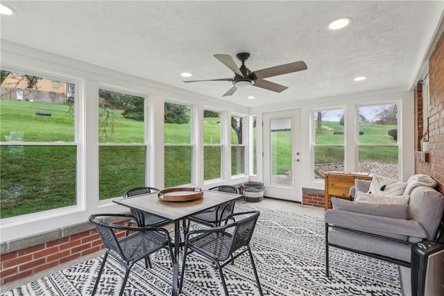 sunroom with a healthy amount of sunlight and ceiling fan