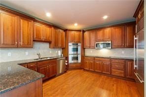 804 Sheriffs Ct, Peters Twp, PA 15317 - kitchen with stainless steel appliances, brown cabinets, backsplash, light wood finished floors, and recessed lighting