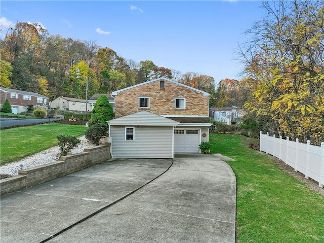 view of home's exterior featuring a lawn, fence, brick siding, an attached garage, and driveway