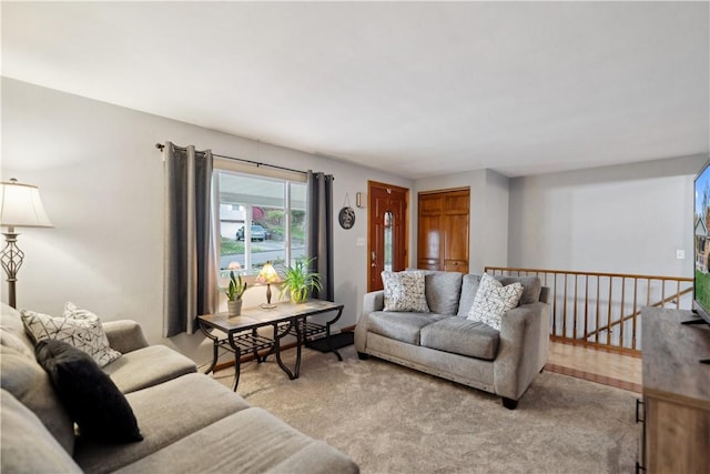 living area featuring light carpet