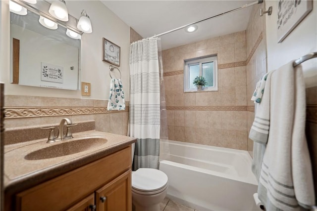 bathroom featuring toilet, tile walls, vanity, and shower / bath combination with curtain