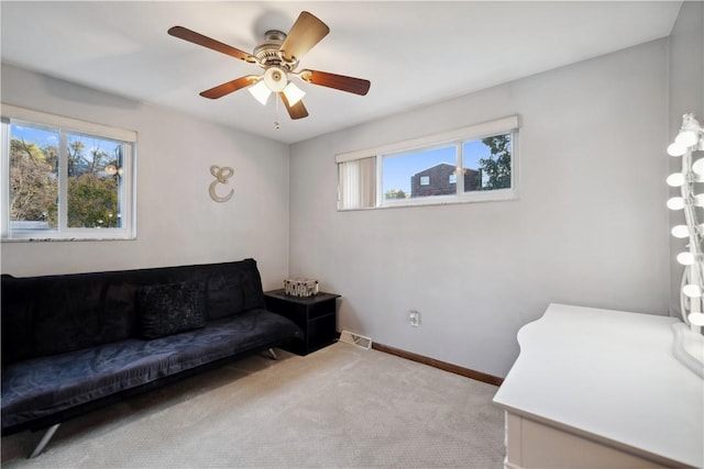 sitting room with carpet flooring, visible vents, baseboards, and ceiling fan