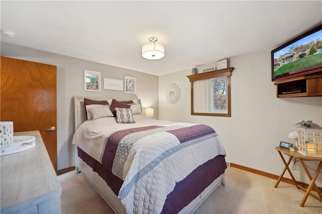 bedroom featuring light colored carpet and baseboards