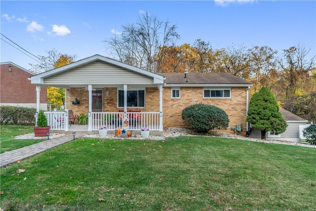 single story home with brick siding, a porch, and a front lawn