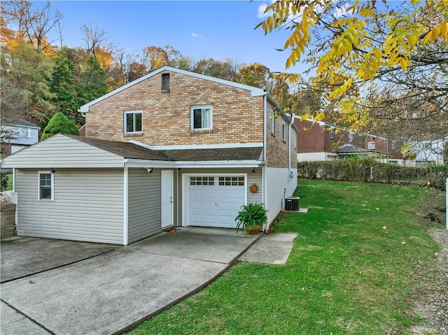 view of side of property featuring driveway, a lawn, a garage, and central air condition unit