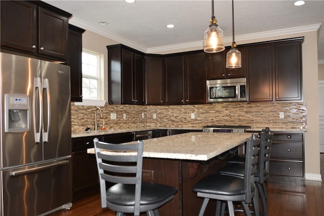 395 Wealdstone Rd, Cranberry Twp, PA 16066 - kitchen with appliances with stainless steel finishes, dark wood finished floors, a kitchen island, dark brown cabinetry, and recessed lighting