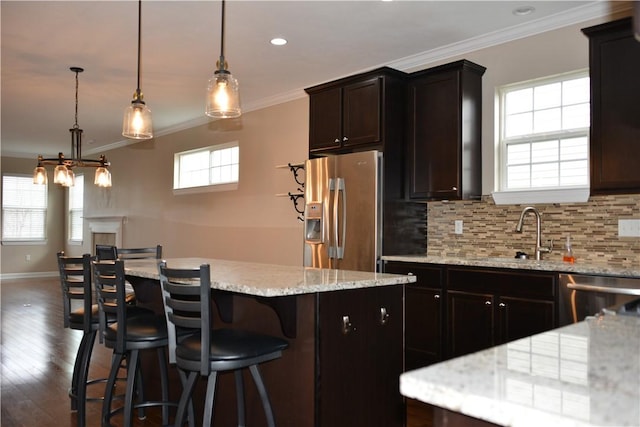 395 Wealdstone Rd, Cranberry Twp, PA 16066 - kitchen featuring appliances with stainless steel finishes, a center island, ornamental molding, dark wood finished floors, and tasteful backsplash