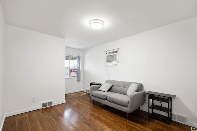 63 Lawn St, Oakland, PA 15213 - living area with visible vents, baseboards, wood-type flooring, and an AC wall unit