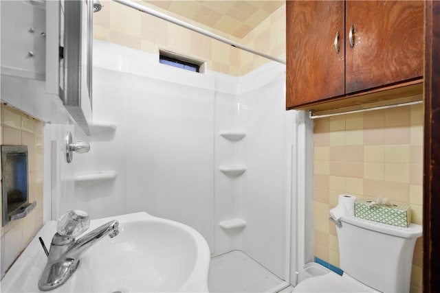 63 Lawn St, Oakland, PA 15213 - bathroom featuring a sink, tile walls, toilet, backsplash, and a stall shower