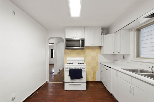 63 Lawn St, Oakland, PA 15213 - kitchen featuring white appliances, arched walkways, visible vents, white cabinets, and a sink