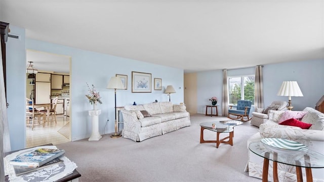 carpeted living area featuring visible vents