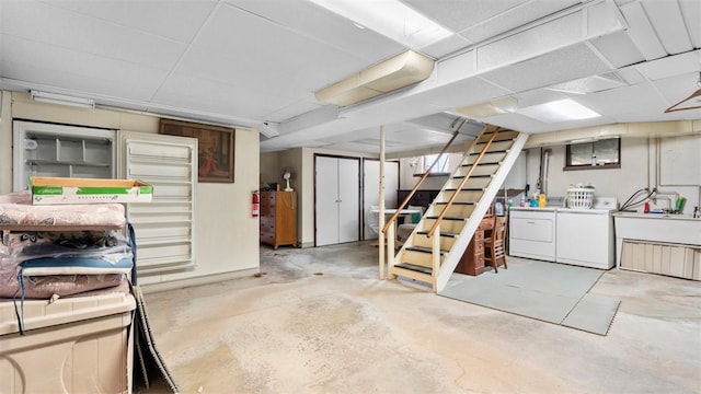 finished basement featuring washer and clothes dryer and stairway