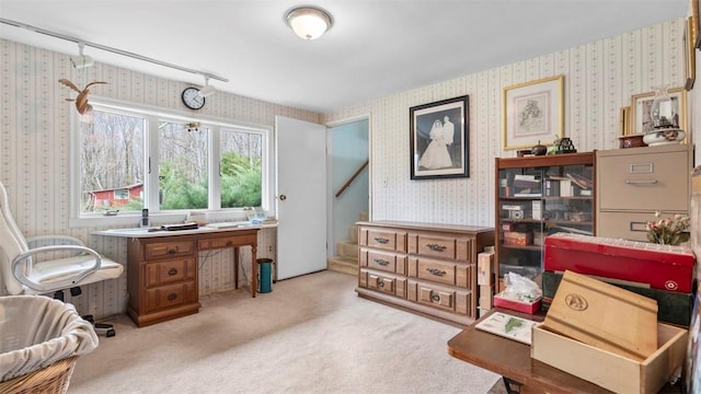 carpeted home office with wallpapered walls