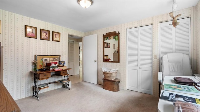 carpeted home office featuring wallpapered walls