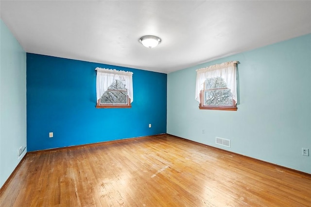 4726 W Barlind Dr, Whitehall, PA 15227 - unfurnished room with healthy amount of natural light, wood finished floors, and baseboards